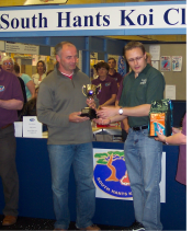 Tim Fisher receiving his trophy from Rupert Bridges (Tetra)